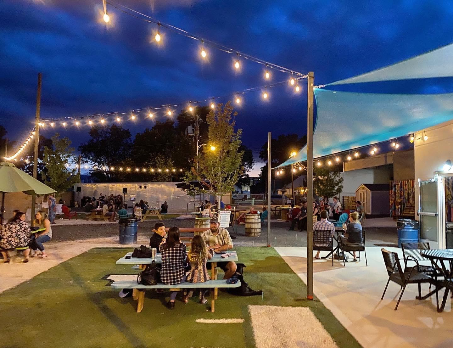 The yard at dusk under string lights